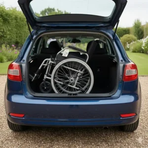 Aluminium folding wheelchair stored neatly in the boot of a standard UK hatchback car.