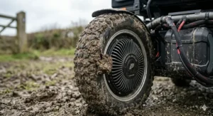 Detailed view of deep-tread pneumatic tyres covered in mud, designed for traction in wet British fields and woodland.