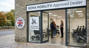 The exterior of a British mobility showroom with a VAT Exempt Mobility Aids sign and a UK Quality Assured badge, featuring the senior man from previous images speaking with a staff member.