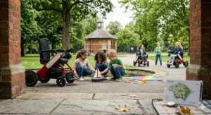 Lightweight, foldable children's electric wheelchair being stored in a car boot.