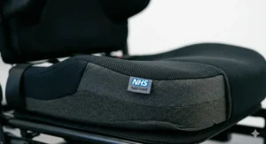 Technical diagram detailing the specialised postural support components of an NHS-approved paediatric powerchair.