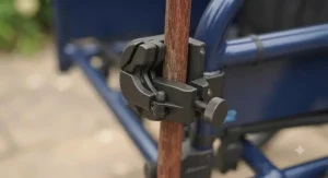 Hand tightening the screw fitting to install the stick holder on a wheelchair frame.