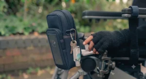 A lightweight, discreet accessory pouch and phone holder attached to a wheelchair.