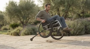 Illustration demonstrating how a rear anti-tip bar prevents a manual wheelchair from tipping backward