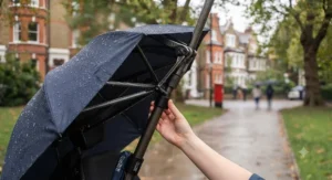 A user enjoying a sunny day outdoors protected by a UV-blocking hands-free wheelchair umbrella.