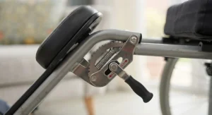 Close-up of an adjustable angle mechanism on wheelchair elevating leg rests for custom positioning.