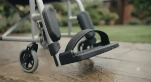 Removable transport wheelchair footrest featuring an integrated heel loop to prevent feet from slipping backward.