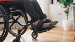 Wheelchair footplates fitted with secure heel loops to prevent feet from slipping backward.