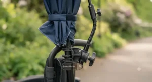 Close-up of a universal clamp securing a clip-on umbrella tightly to a wheelchair frame.